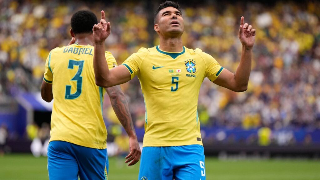 Brazil players celebrate after their 2-1 win over Japan in the World Cup round of 32